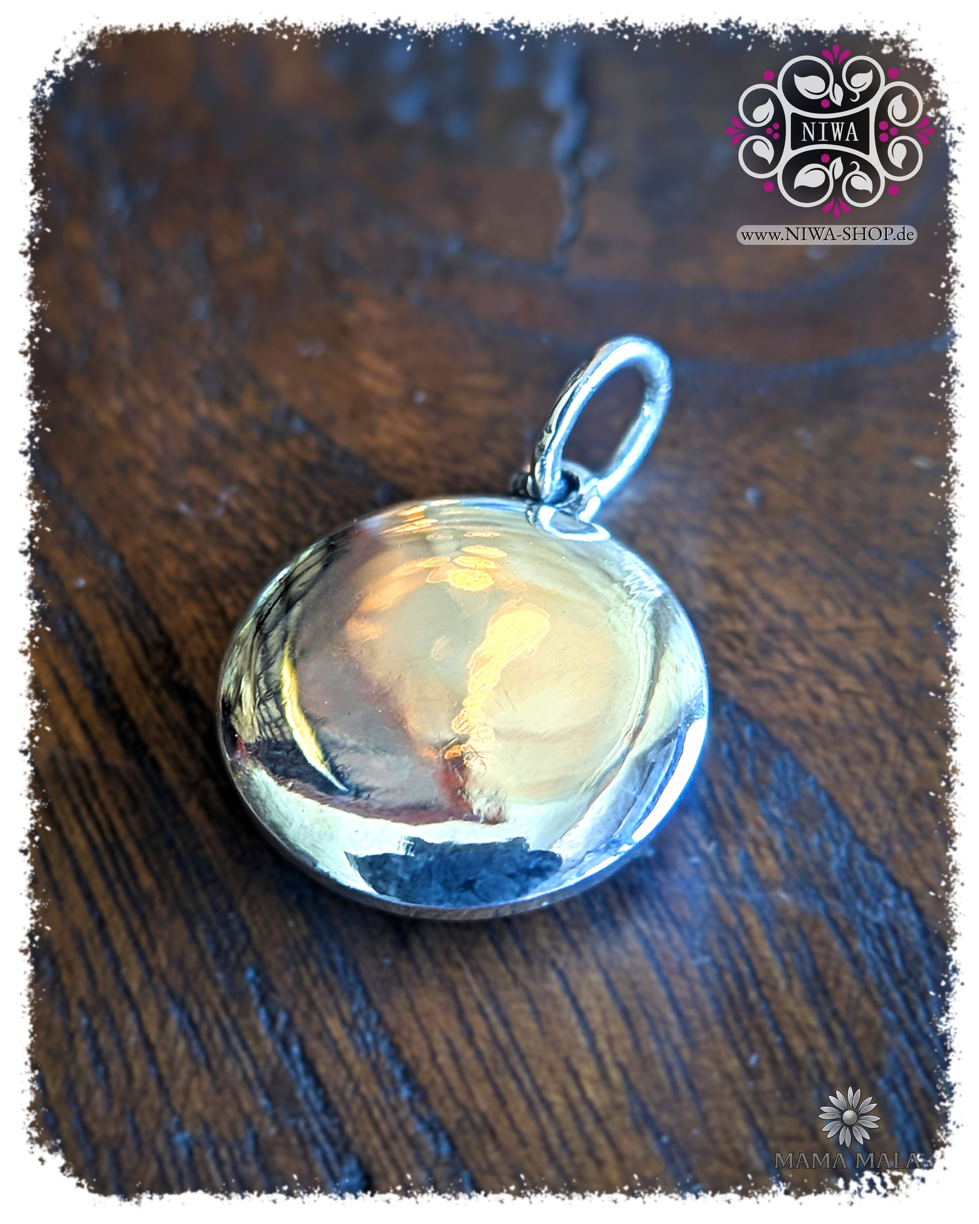 Back of the PANG SAI YAT COIN Dangle made of solid 925 sterling silver, smooth polished back with eyelet on dark wood.