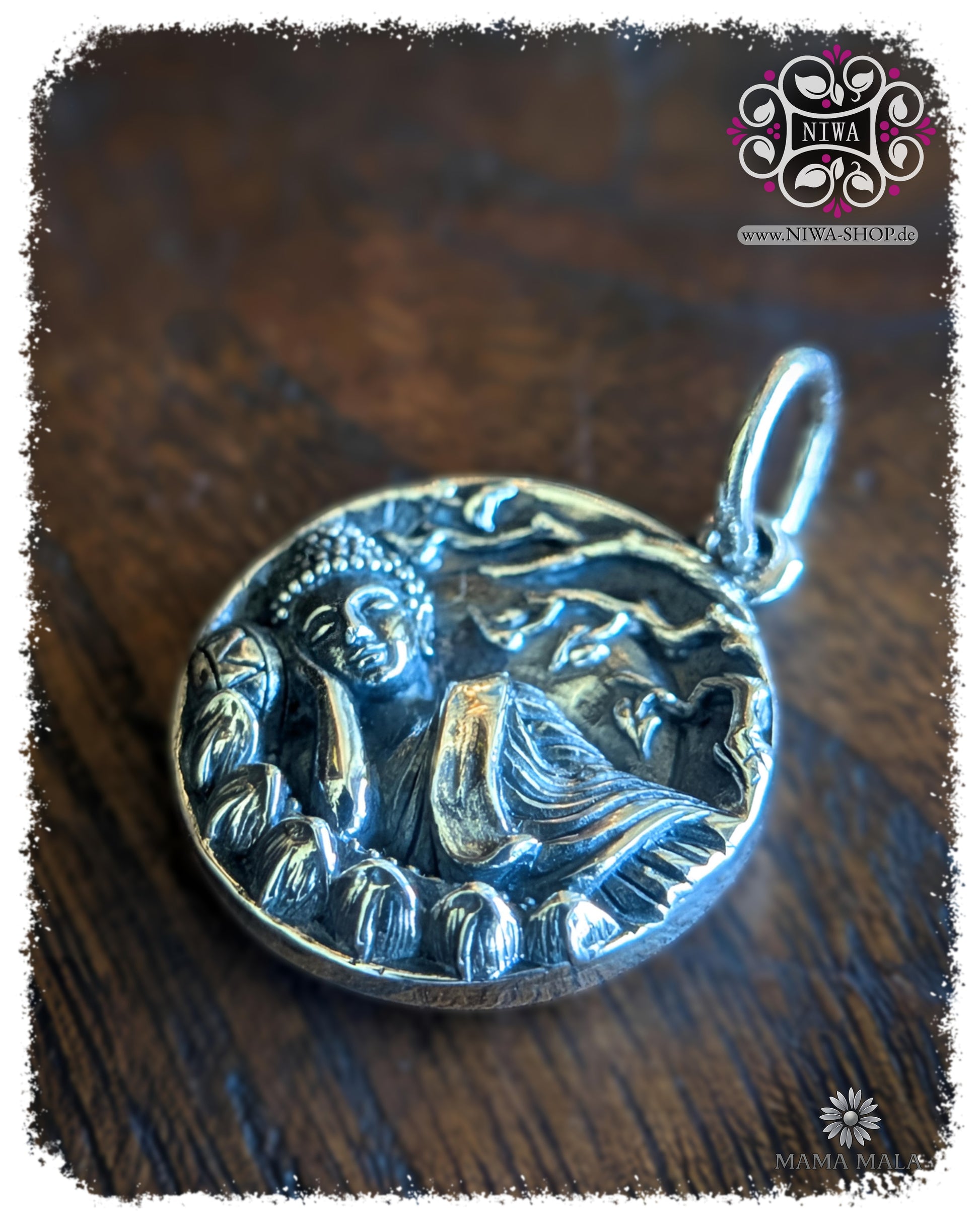 PANG SAI YAT COIN Dangle in side view, detailed Tuesday Buddha made of 925 sterling silver with a lying Buddha representation and organic relief on a dark wooden structure.