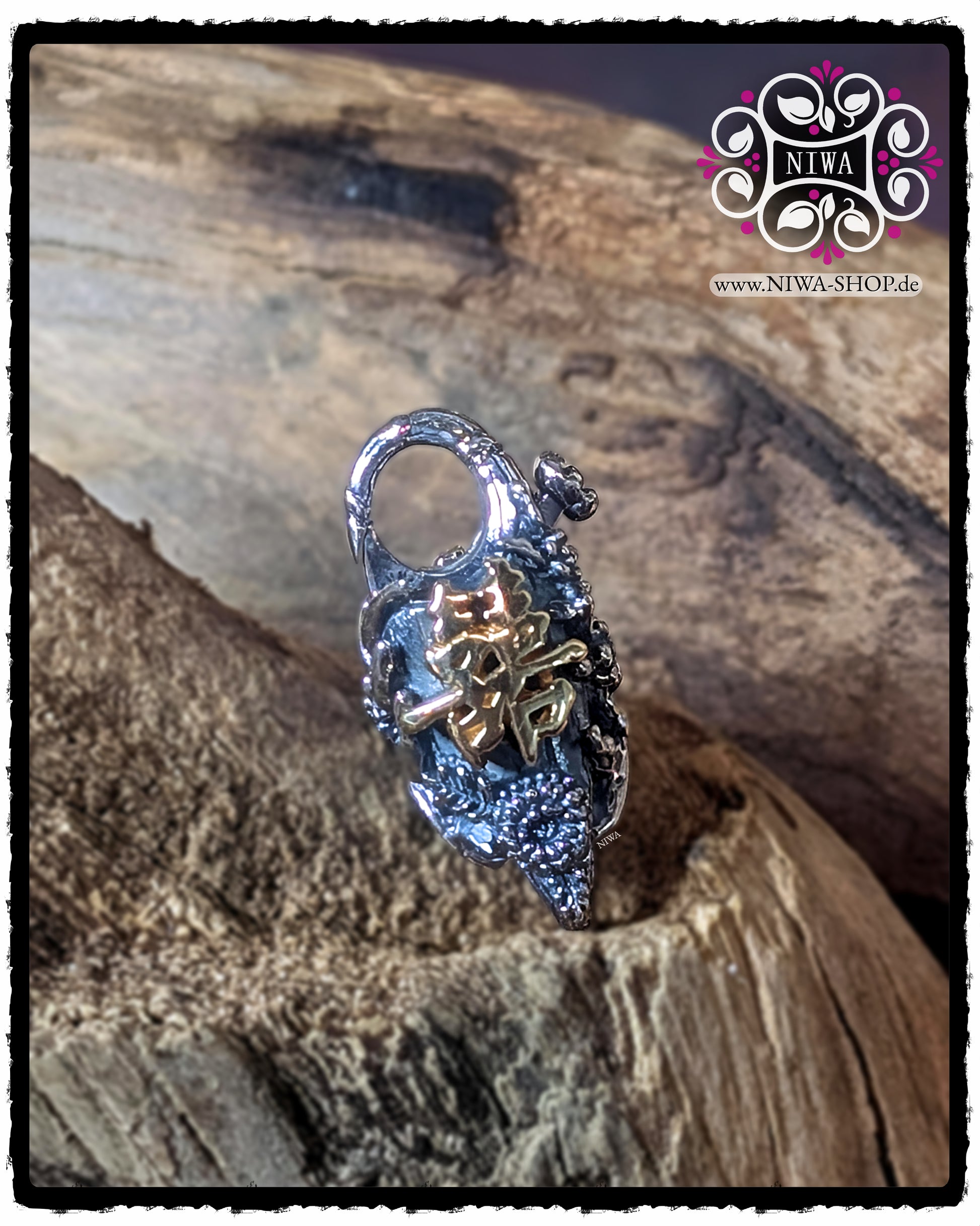 CHINESE DOUBLE HAPPINESS Lock front view with raised DOUBLE HAPPINESS lettering made of 18K yellow gold on a structured LOTUS and flower surface made of 925 STERLING SILVER, presented on wood.