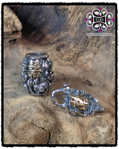 CHINESE DOUBLE HAPPINESS BarrelCharm with 18K yellow gold characters together with matching CHINESE DOUBLE HAPPINESS Lock, both arranged in a floral LOTUS design against a wooden background.