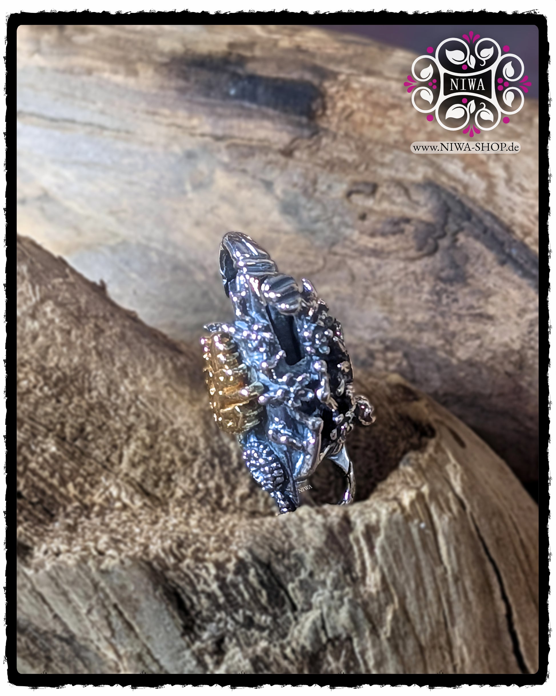 CHINESE DOUBLE HAPPINESS Lock side view with curved LOTUS LEAVES and dense flower relief made of 925 STERLING SILVER, decoratively photographed on a piece of wood.