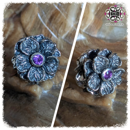 VIOLET AMETHYST FORGET ME NOT Charm, NIWABEADS FLORAL GLORY, solid 925 STERLING SILVER, collage with front view and side view, violet gemstone in setting, plastic flower, structured surface, stone background.
