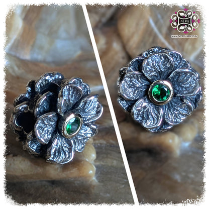 GREEN TSAVORIT FORGET ME NOT Charm, NIWABEADS FLORAL GLORY, TWOTONE, solid 925 STERLING SILVER with solid 14K YELLOW GOLD MOUNT, collage with front view of flower and slanted side view, genuine gemstone, textured petals, stone background.