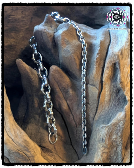 HALF-HALF bracelet BYGONE made of 925 sterling silver, solid link half and fine chain half, hanging freely in front of a wooden structure