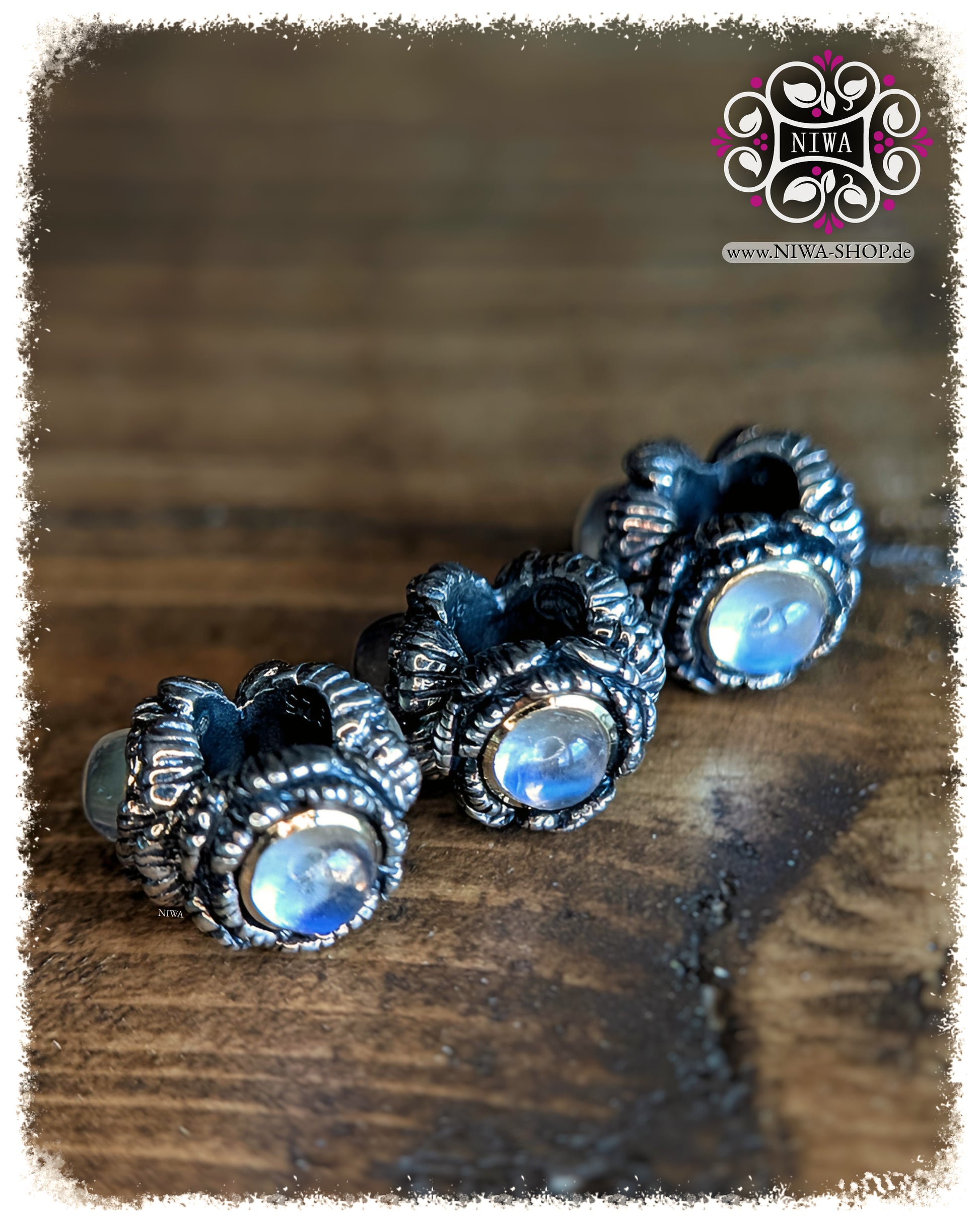 BABY PEONY BLOOM MiniCharm Cabochon Edition with blue moonstone, three MiniCharms in front view on wooden surface by NIWABeads