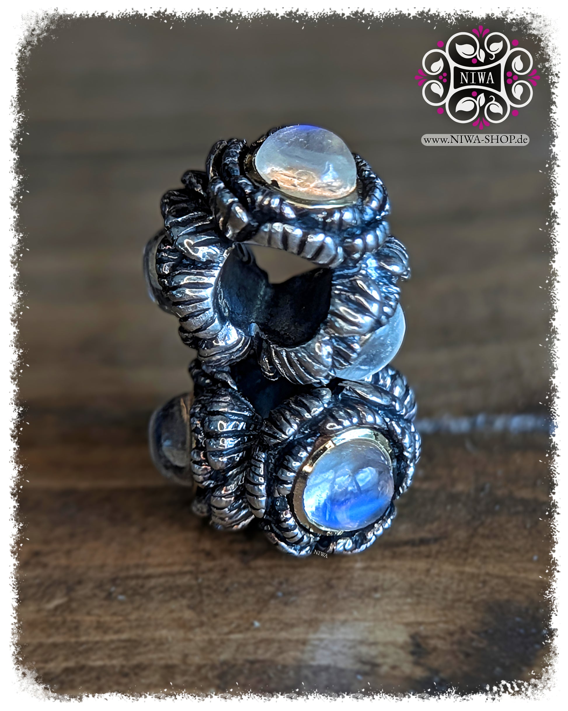 BABY PEONY BLOOM MiniCharm Cabochon Edition with blue moonstone, two MiniCharms in side view on wooden surface by NIWABeads