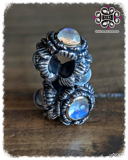 BABY PEONY BLOOM MiniCharm Cabochon Edition with blue moonstone, two MiniCharms in side view on wooden surface by NIWABeads